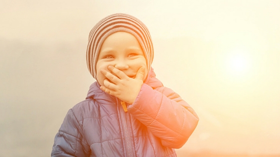 little boy smiling in sunset