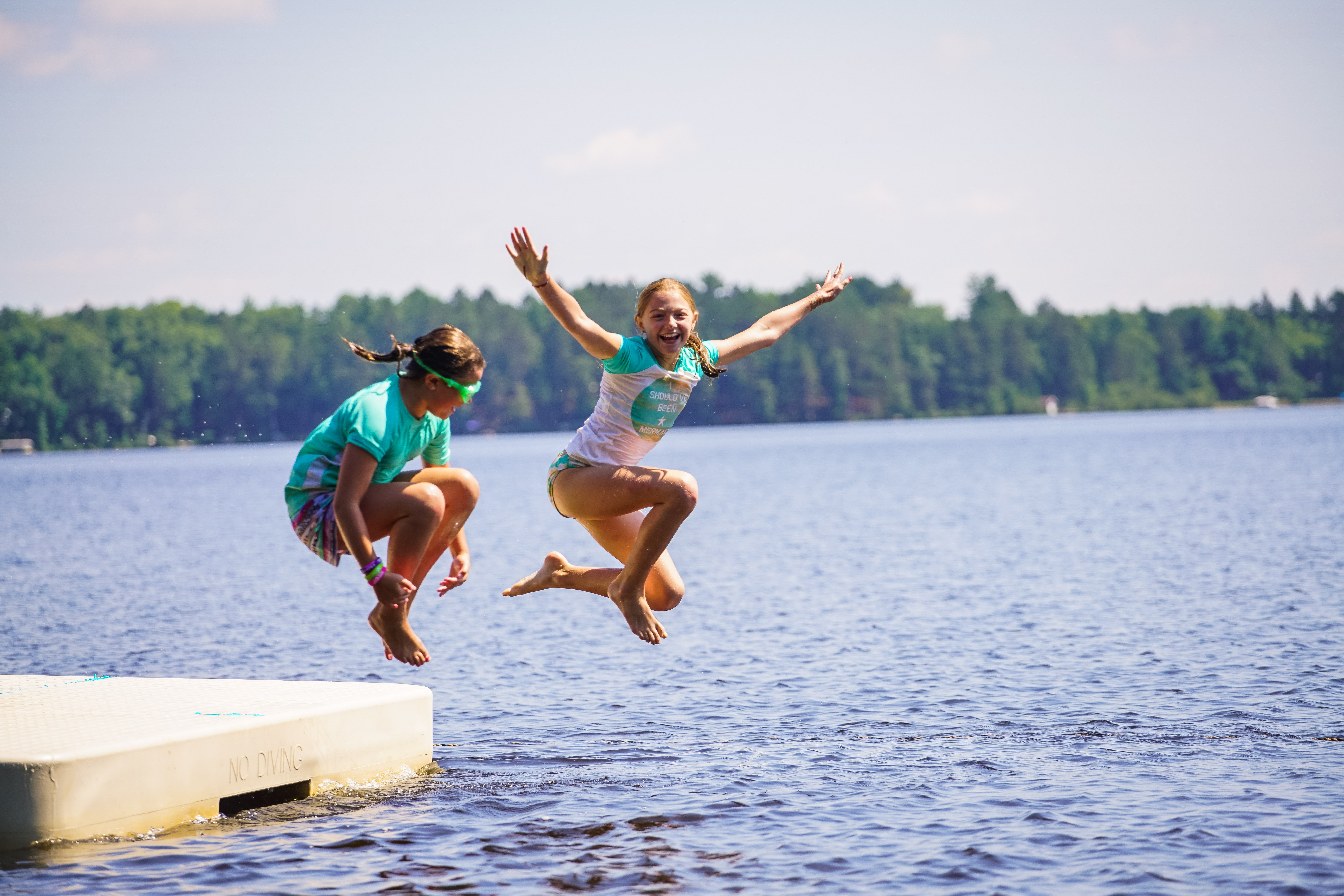 girls jump swim raft