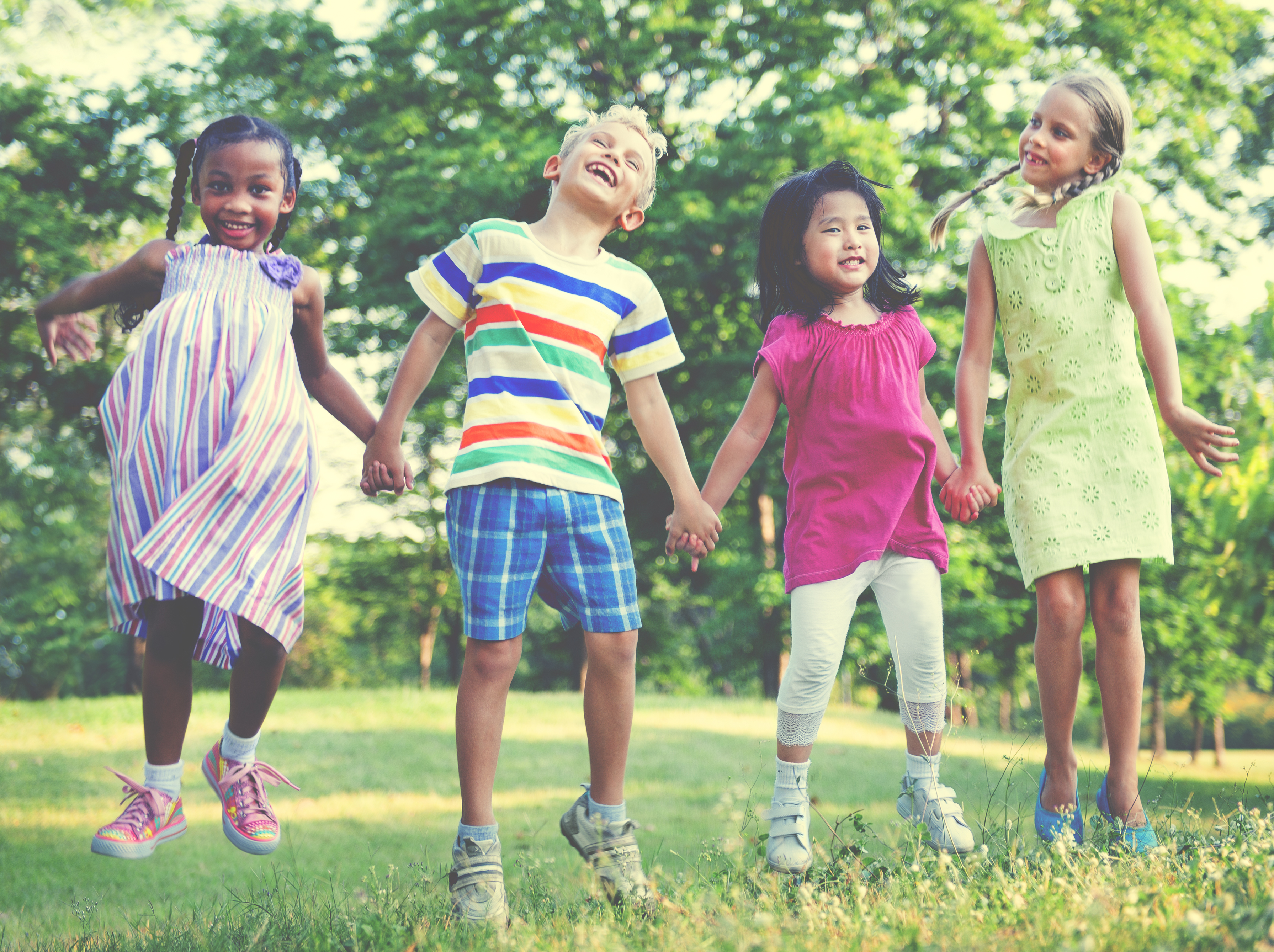 four friends jumping outside