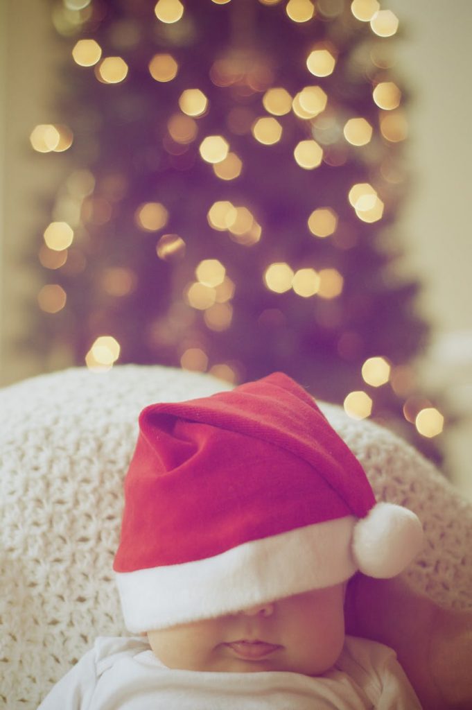 baby asleep with holiday hat